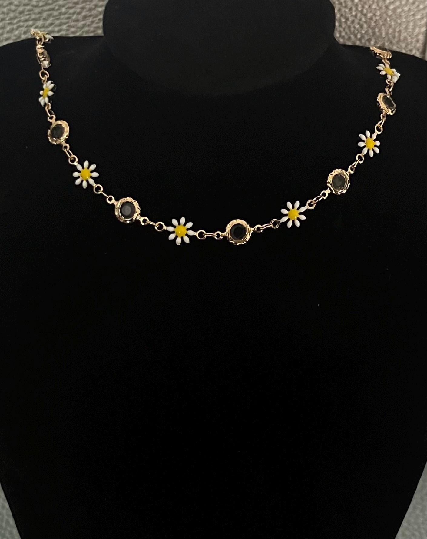 Gold Daisy Chain Necklace featuring charming floral links, ideal for adding a touch of elegance to any outfit, perfect for spring and summer styling.