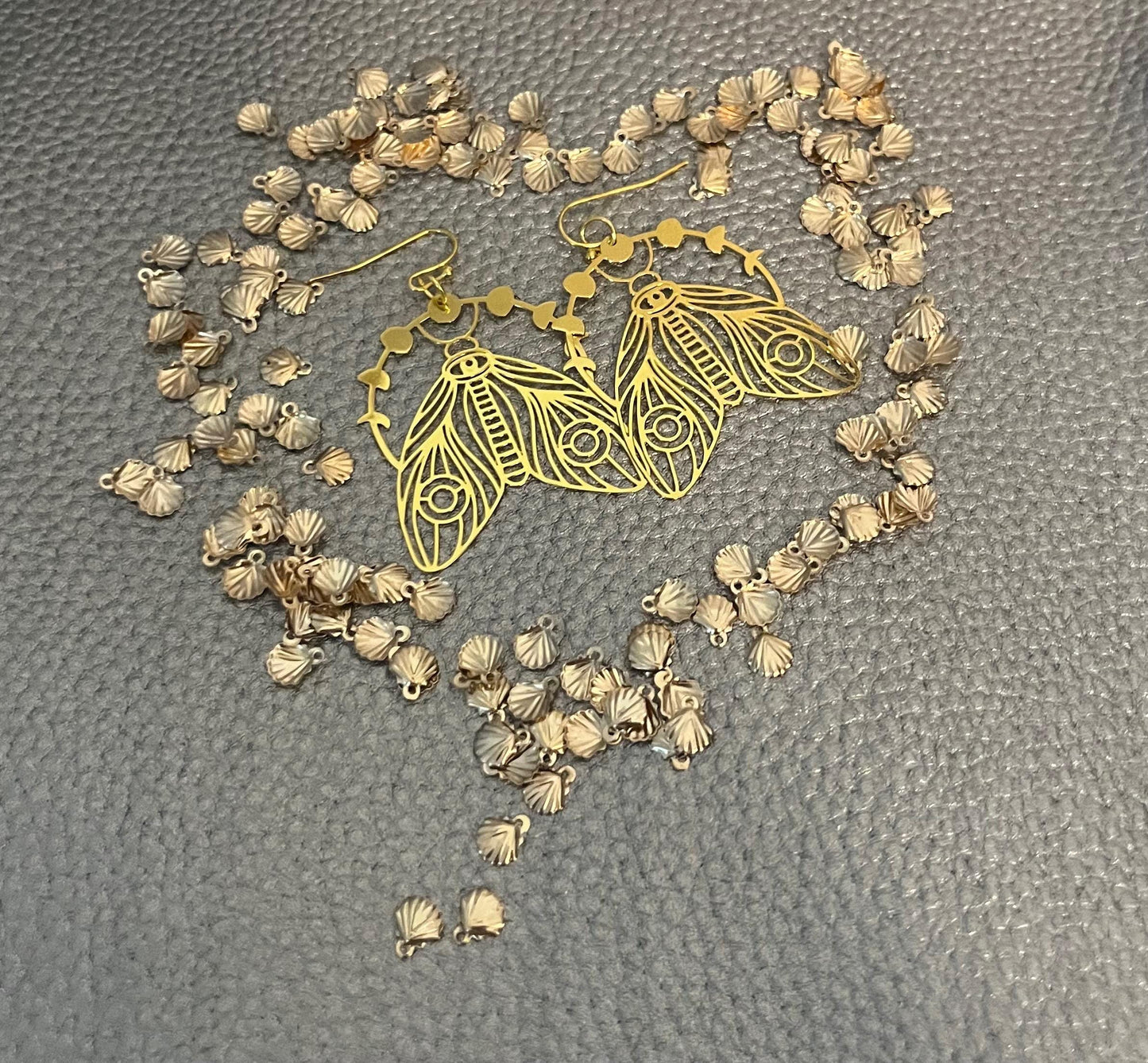 Elegant gold moth dangly earrings, featuring intricate design and lightweight construction, perfect for adding a unique touch to any outfit.