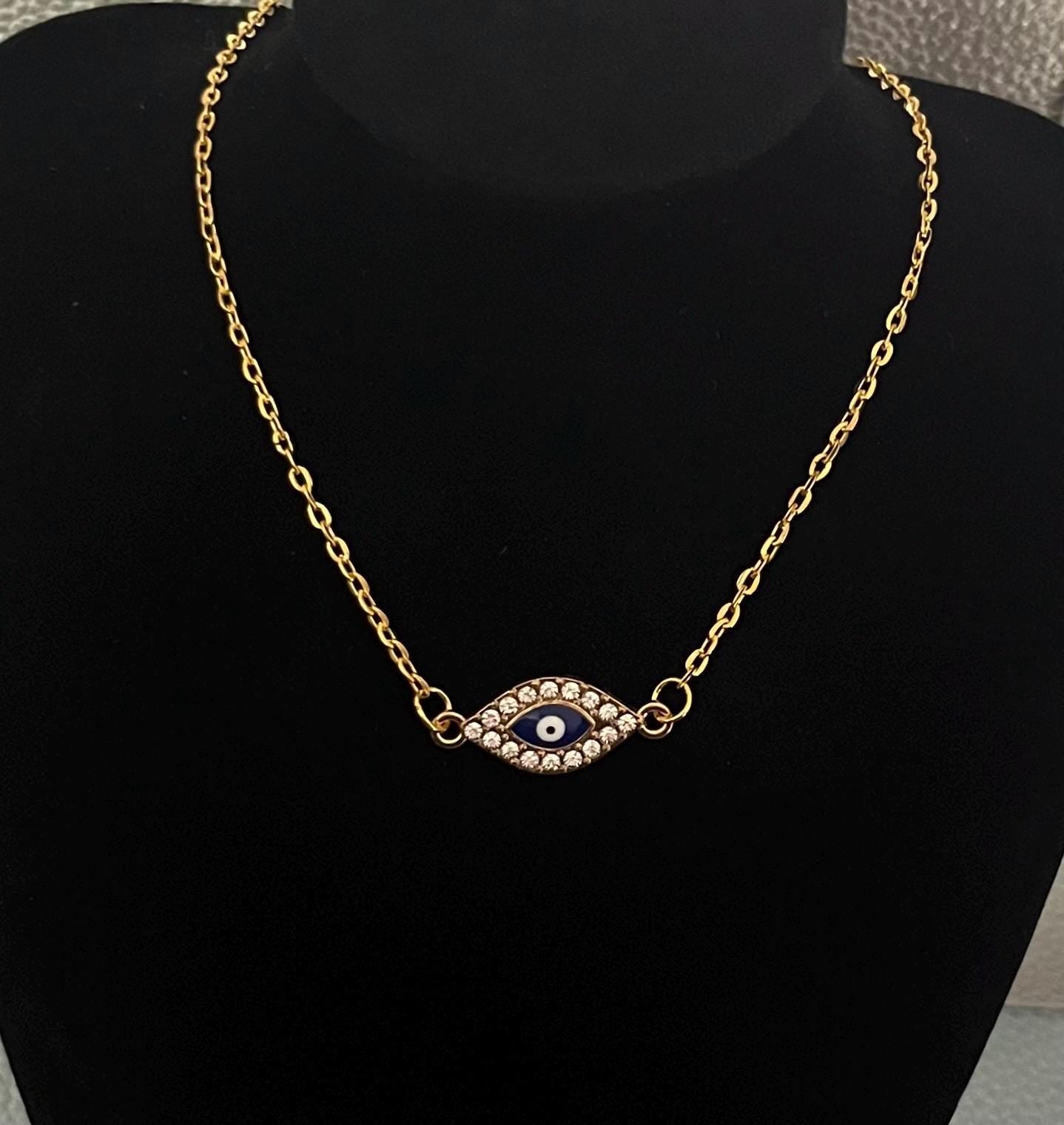 Gold Diamante Evil Eye Pendant Necklace adorned with sparkling crystals, symbolizing protection and style, perfect for layering or as a statement piece.