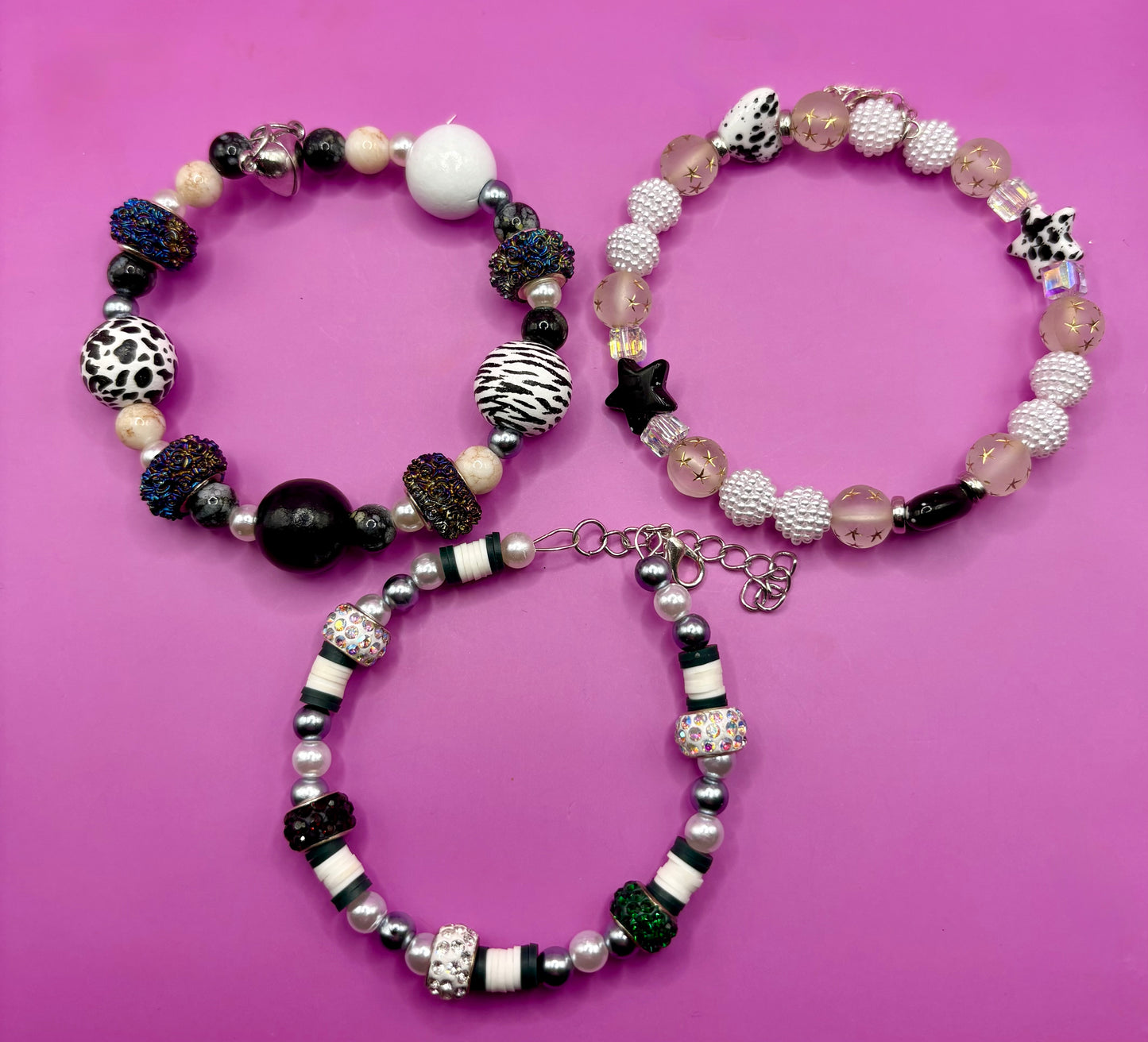 Handmade beaded charm bracelets stacked together, showcasing unique designs and vibrant colors, perfect for adding a personalized touch to any jewelry collection. black and white animal zebra cow print star beads