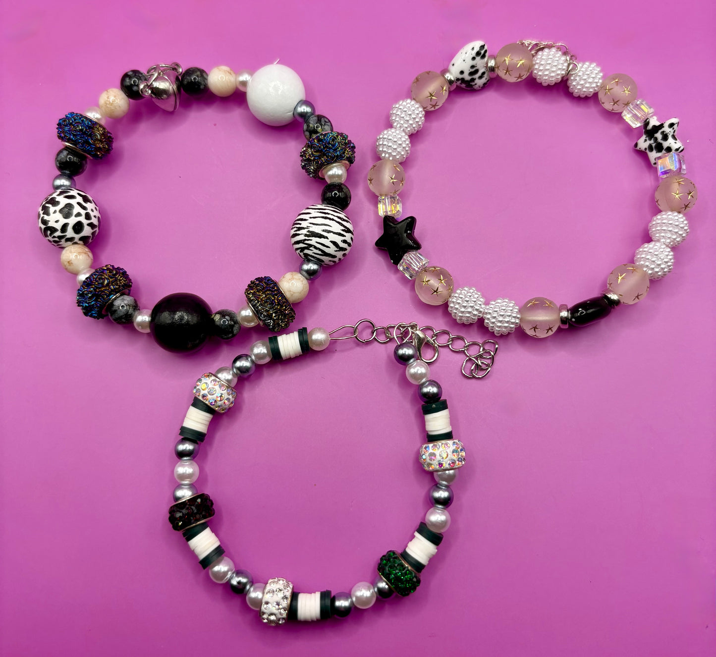 Handmade beaded charm bracelets stacked together, showcasing unique designs and vibrant colors, perfect for adding a personalized touch to any jewelry collection. black and white animal zebra cow print star beads