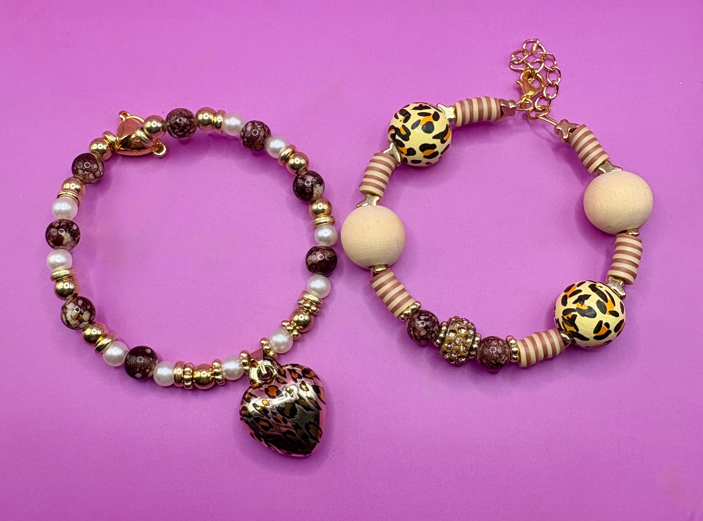 Handmade beaded charm bracelets stacked together, showcasing unique designs and vibrant colors, perfect for adding a personalized touch to any jewelry collection. tan brown leopard print animal print heart pendant