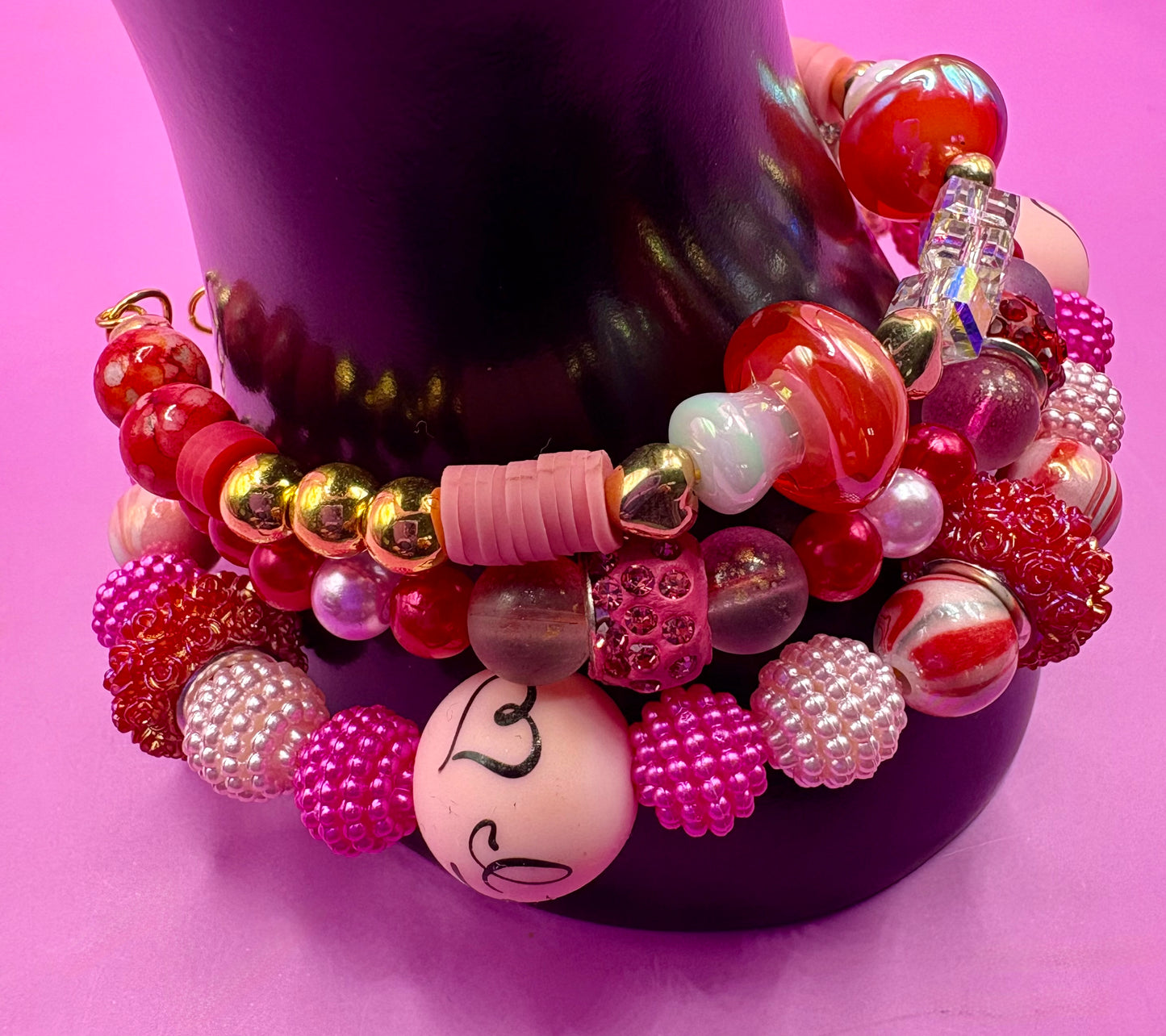 Handmade beaded charm bracelets stacked together, showcasing unique designs and vibrant colors, perfect for adding a personalized touch to any jewelry collection. red toadstool fairy I love you romantic bracelet