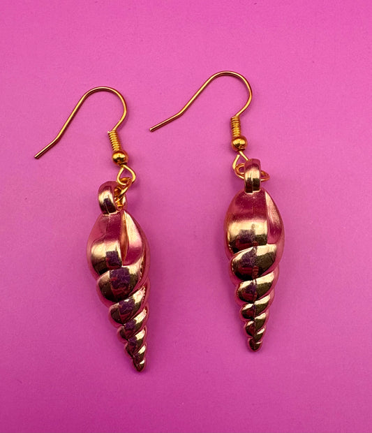 Elegant gold sea shell horn earrings, featuring a unique coastal-inspired design that adds a touch of beachy charm and sophistication to any outfit.