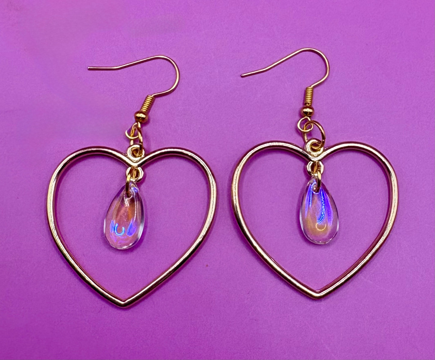 Stylish silver heart hoop dangly earrings, featuring a trendy design perfect for adding a romantic touch to any outfit.