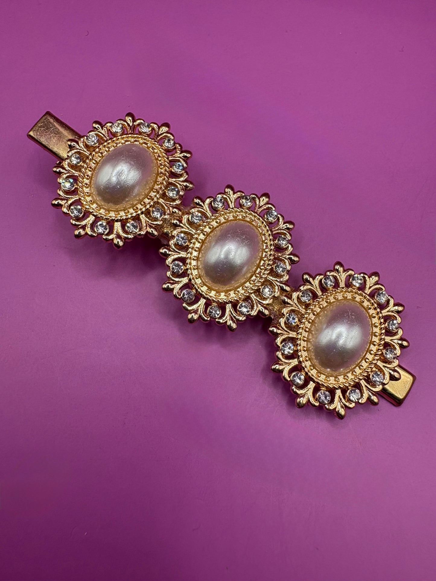 Elegant gold oval hair clip featuring pearl-style embellishments and sparkling rhinestones, measuring 8cm long, perfect for making a statement in any hairstyle for special occasions or everyday wear.