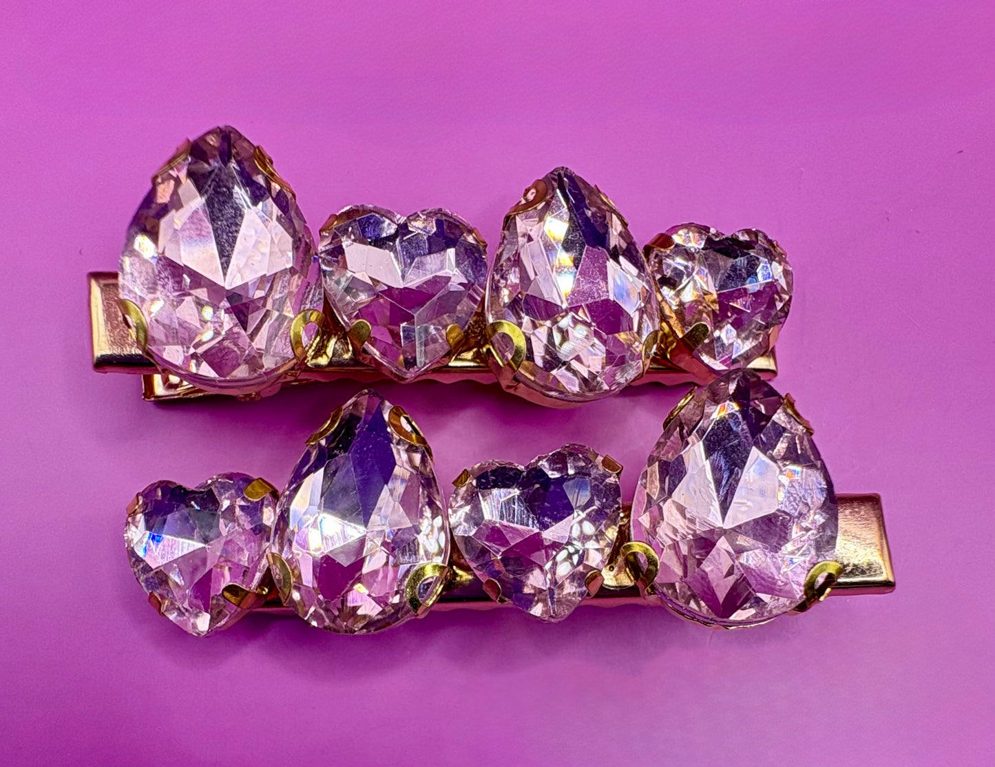 Elegant pair of pink and purple gemstone hair slides, ideal for enhancing your hairstyle with a touch of glamour and color.