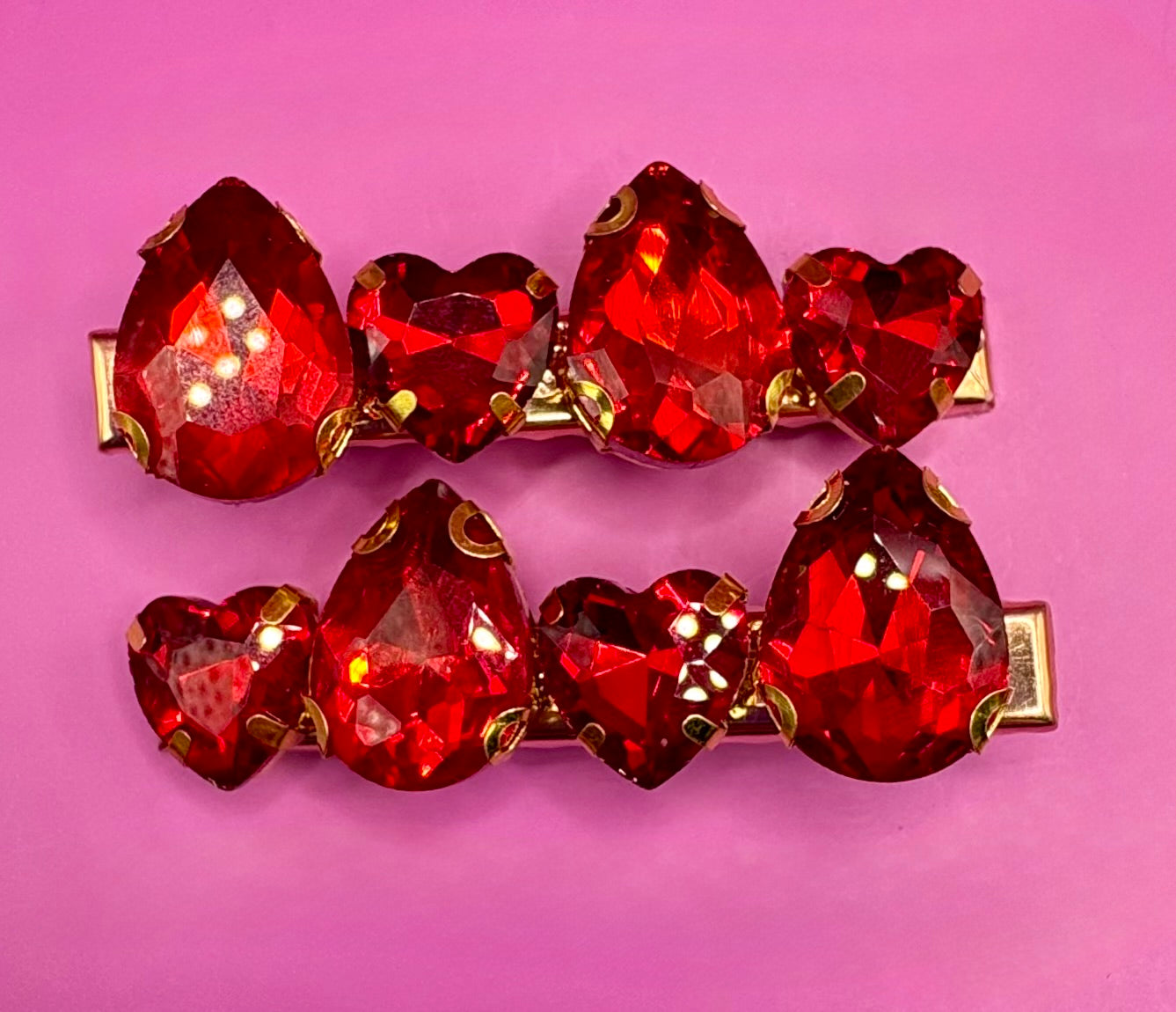 Elegant pair of pink and purple gemstone hair slides, ideal for enhancing your hairstyle with a touch of glamour and color.
