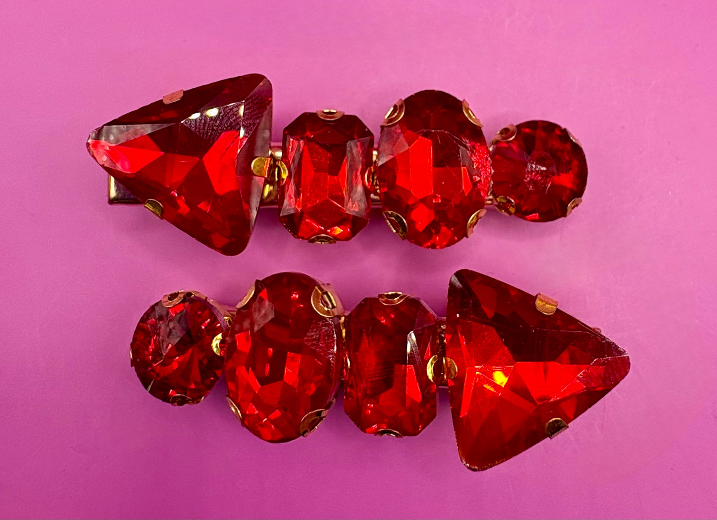 Elegant pair of pink and purple gemstone hair slides, ideal for enhancing your hairstyle with a touch of glamour and color.
