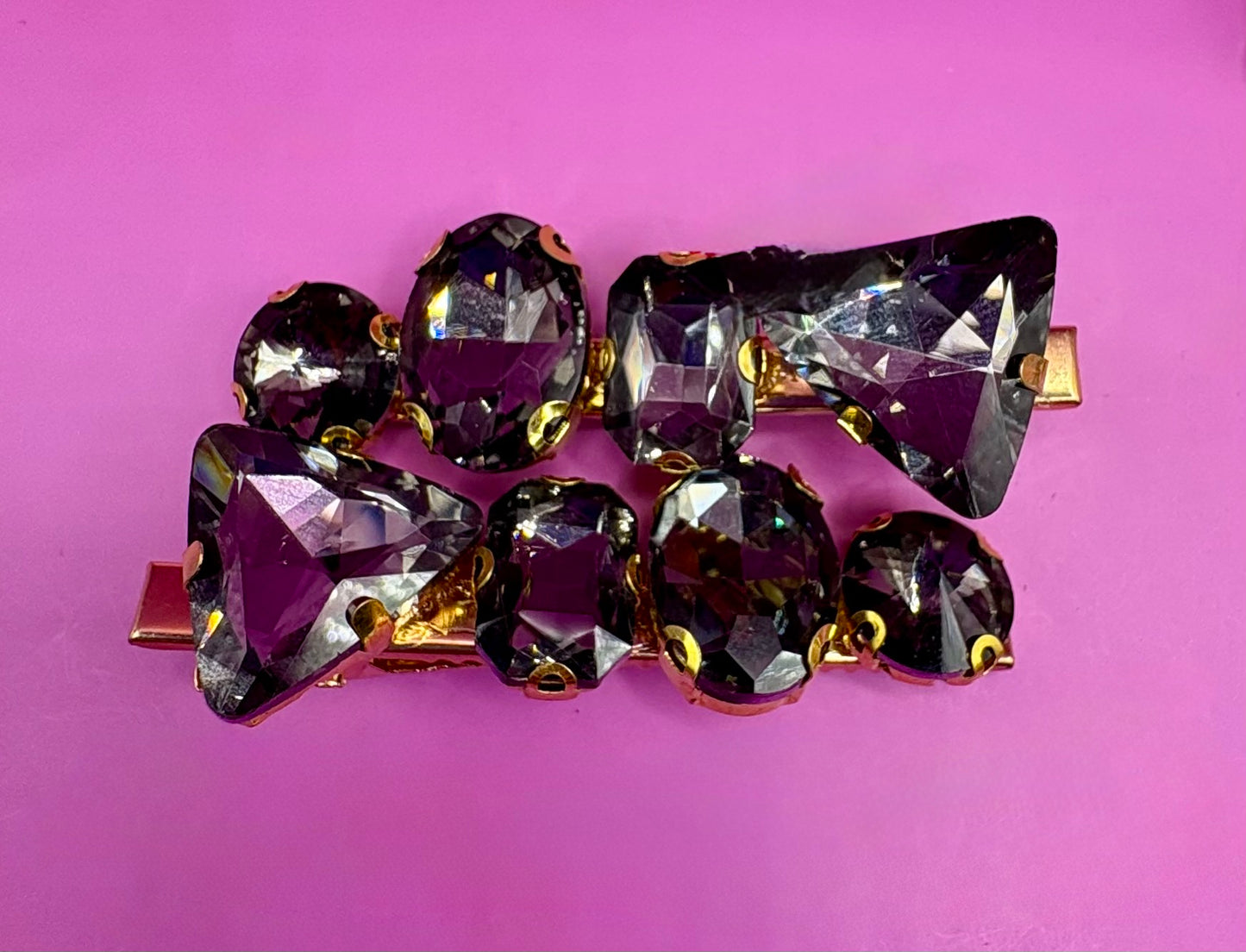 Elegant pair of pink and purple gemstone hair slides, ideal for enhancing your hairstyle with a touch of glamour and color.