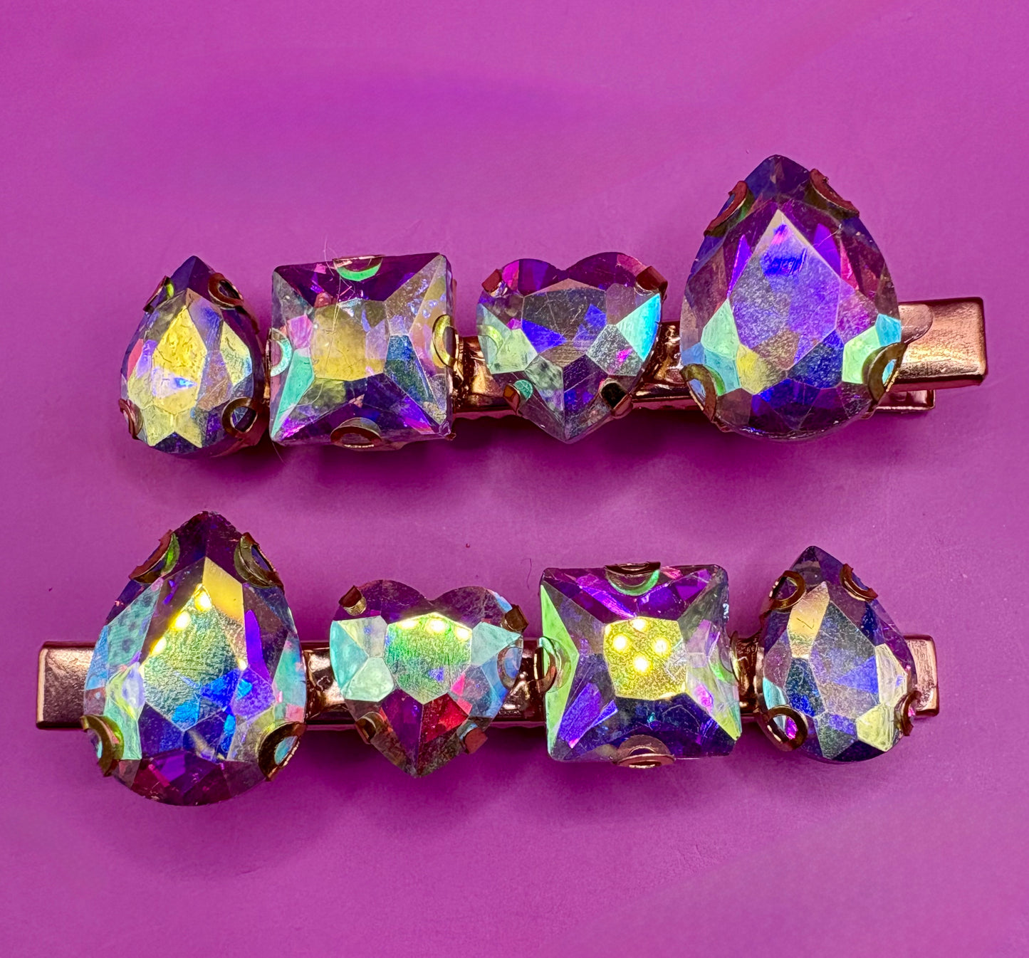Elegant pair of pink and purple gemstone hair slides, ideal for enhancing your hairstyle with a touch of glamour and color.