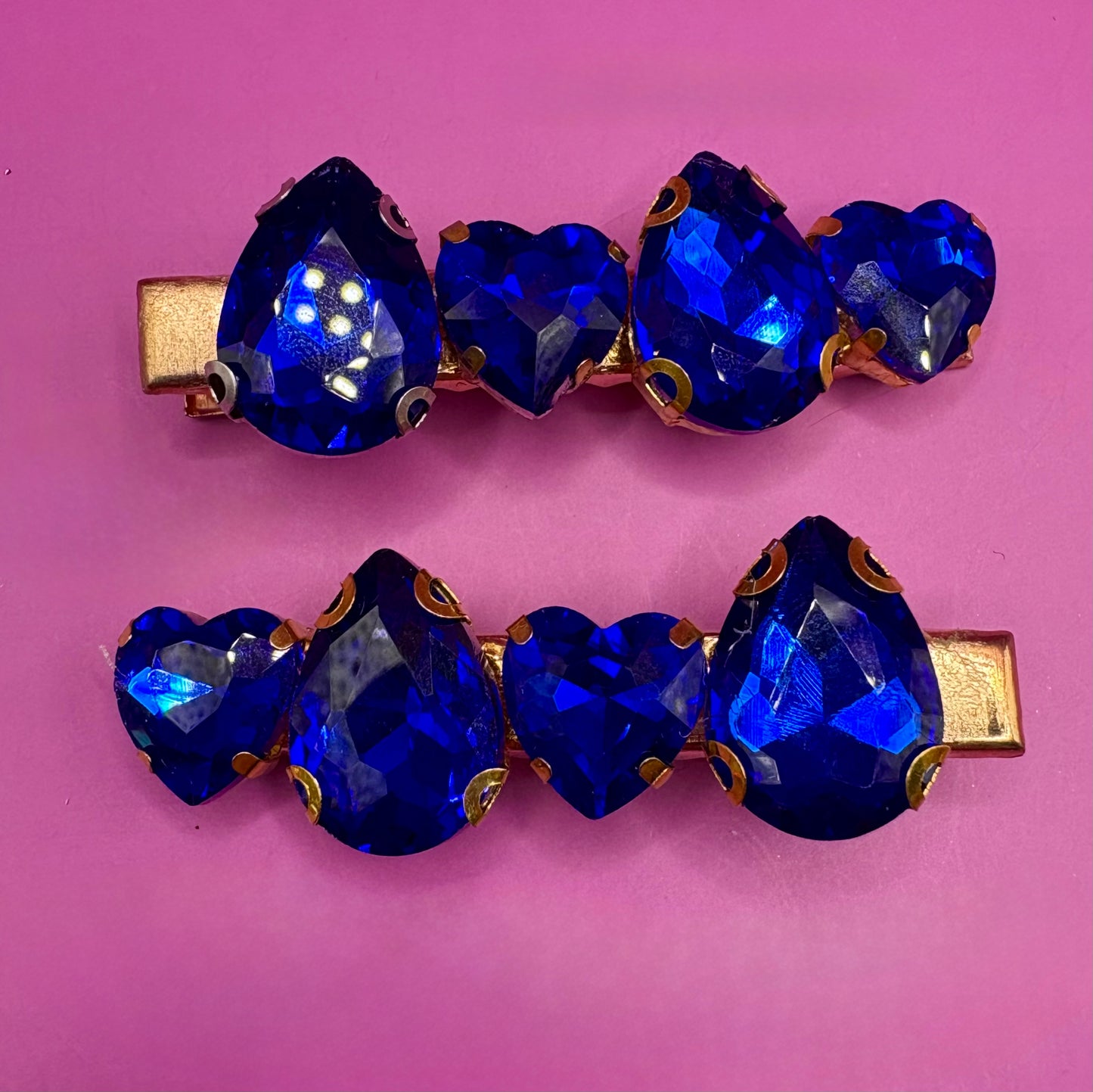 Elegant pair of pink and purple gemstone hair slides, ideal for enhancing your hairstyle with a touch of glamour and color.