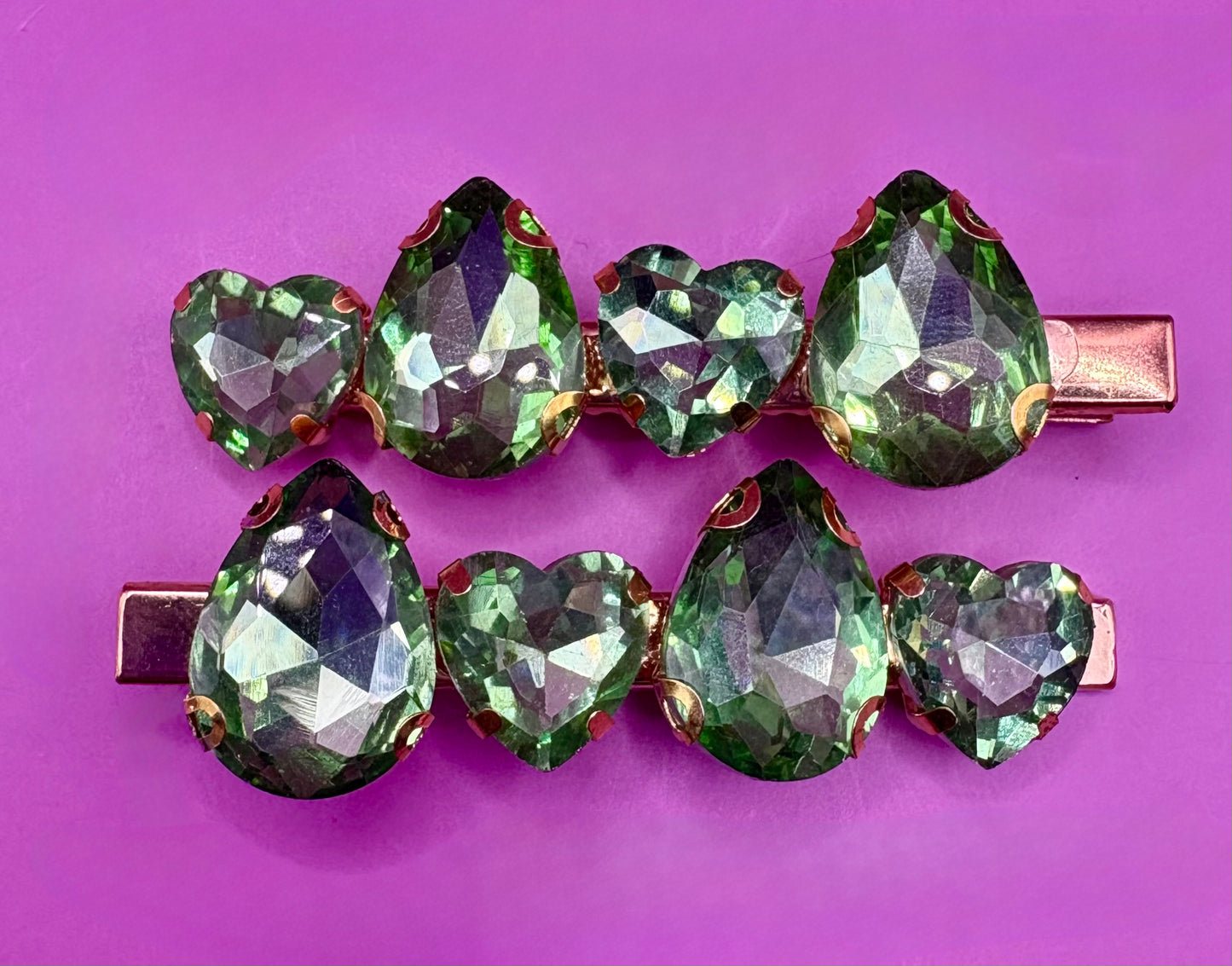 Elegant pair of pink and purple gemstone hair slides, ideal for enhancing your hairstyle with a touch of glamour and color.