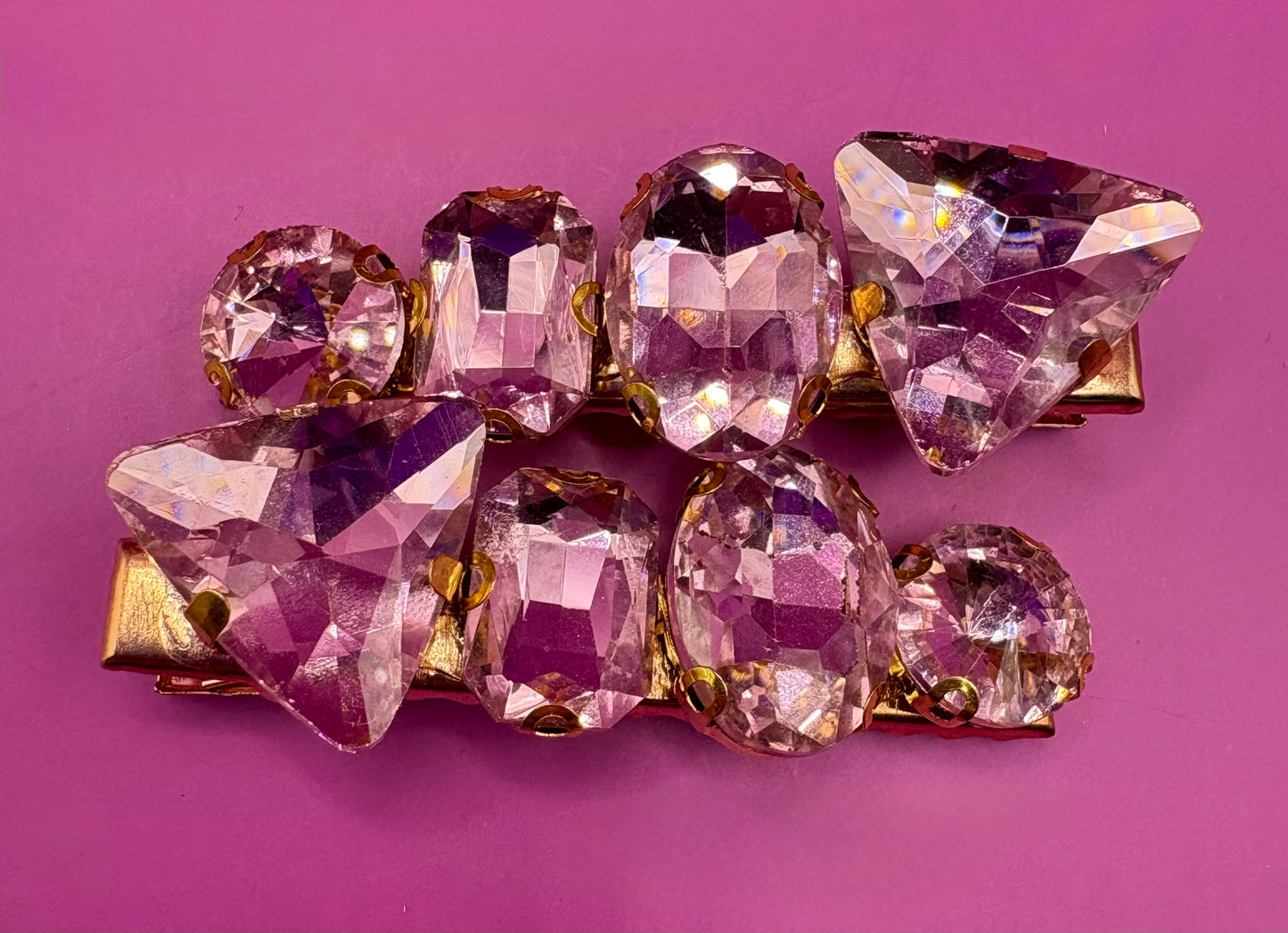 Elegant pair of pink and purple gemstone hair slides, ideal for enhancing your hairstyle with a touch of glamour and color.