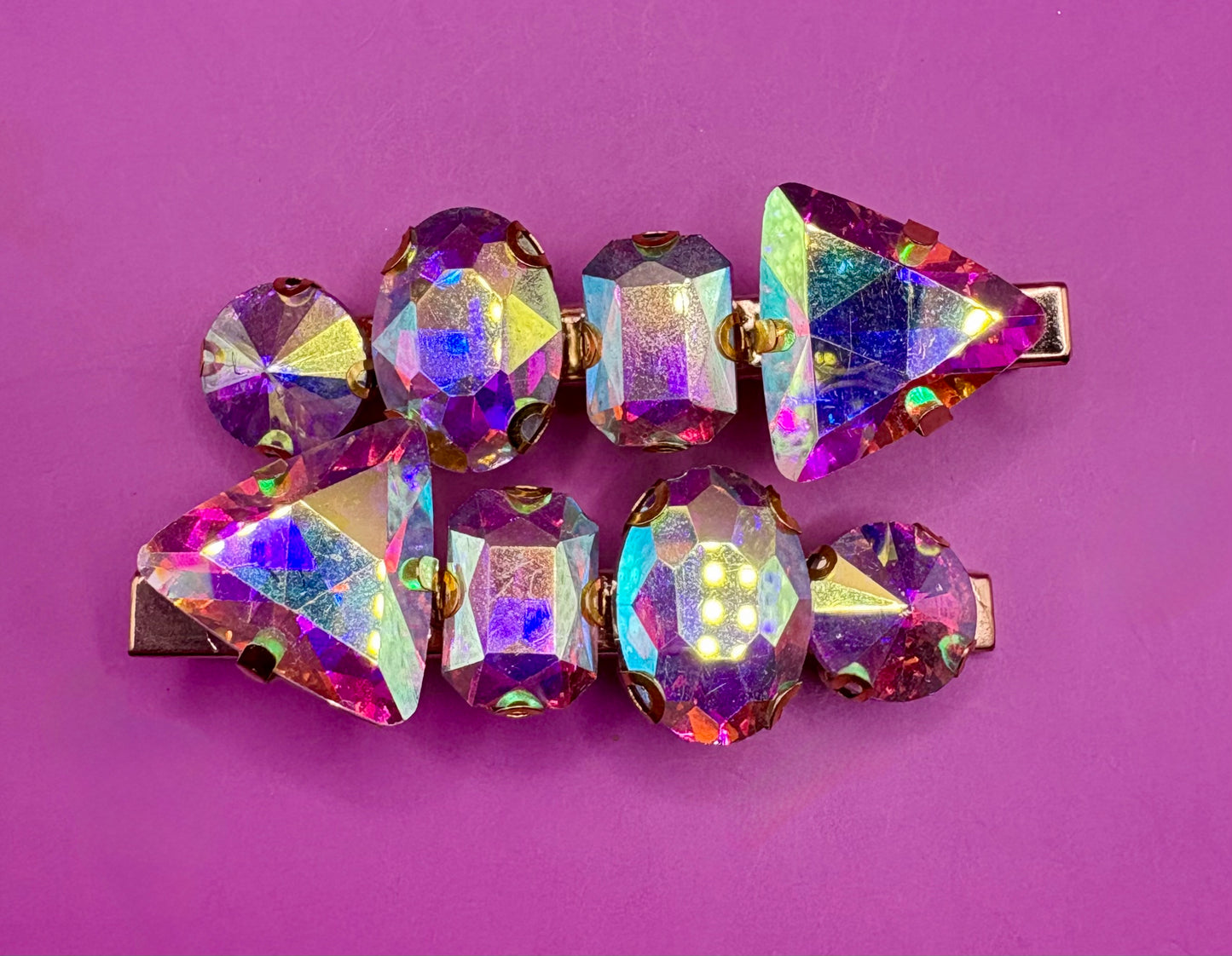 Elegant pair of pink and purple gemstone hair slides, ideal for enhancing your hairstyle with a touch of glamour and color.