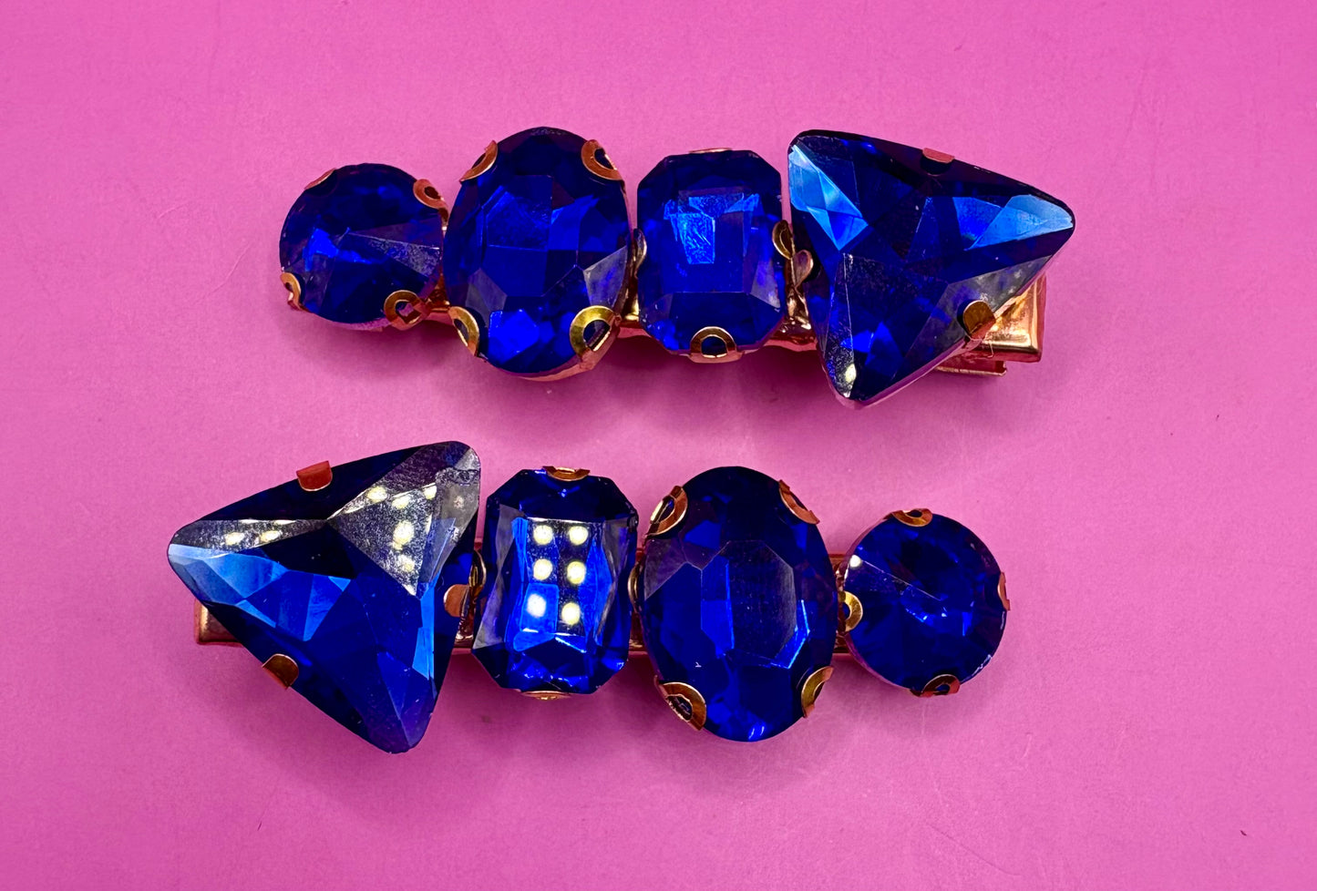 Elegant pair of pink and purple gemstone hair slides, ideal for enhancing your hairstyle with a touch of glamour and color.