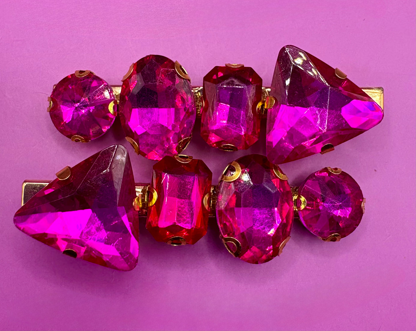 Elegant pair of pink and purple gemstone hair slides, ideal for enhancing your hairstyle with a touch of glamour and color.