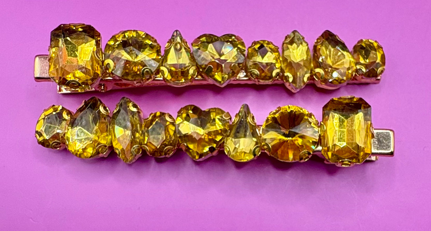 Stylish pair of large gemstone hair slides featuring vibrant colors, perfect for adding a chic and fashionable touch to any hairstyle.