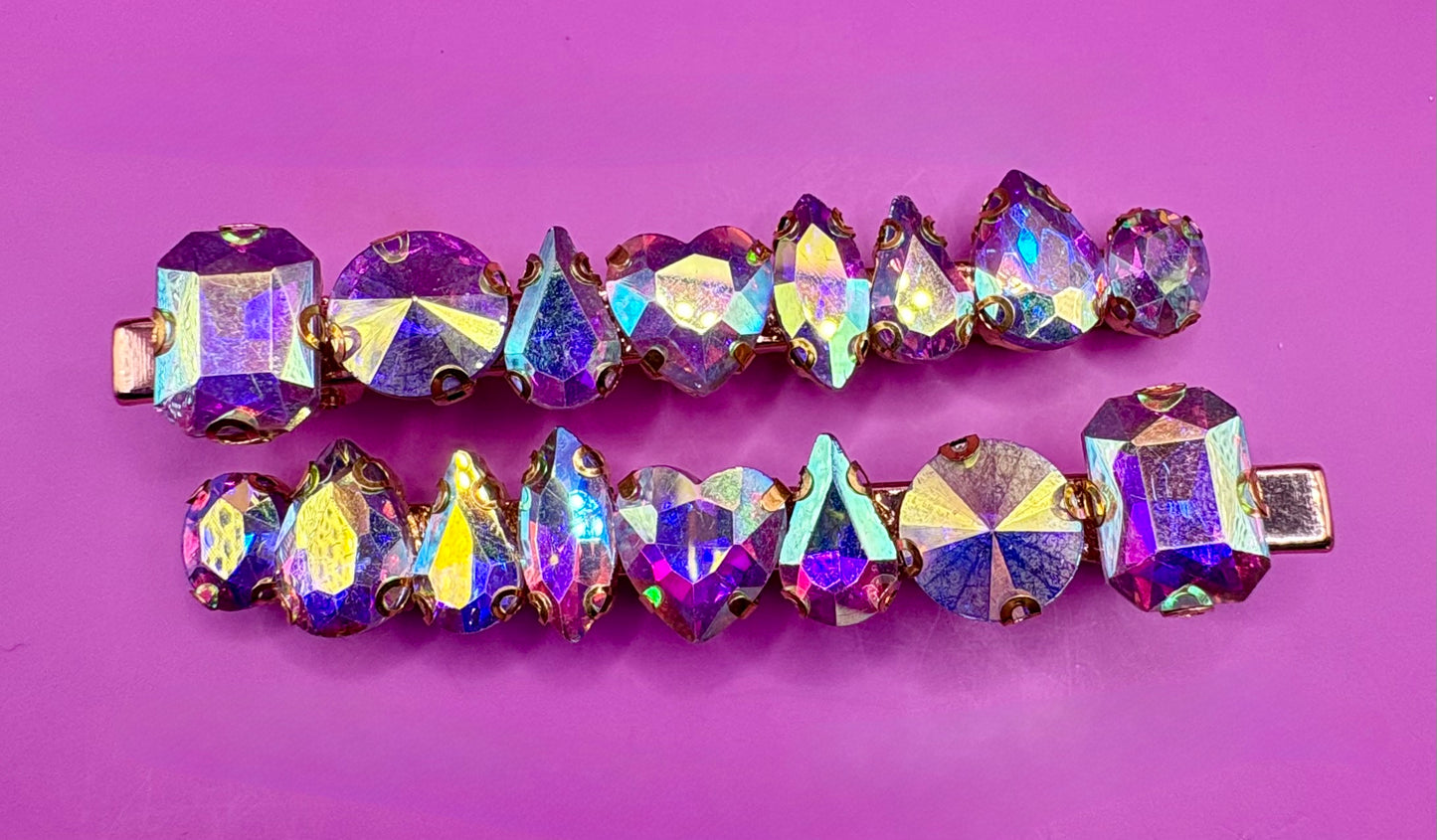 Stylish pair of large gemstone hair slides featuring vibrant colors, perfect for adding a chic and fashionable touch to any hairstyle.