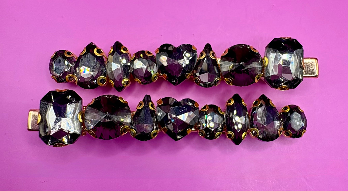 Stylish pair of large gemstone hair slides featuring vibrant colors, perfect for adding a chic and fashionable touch to any hairstyle.