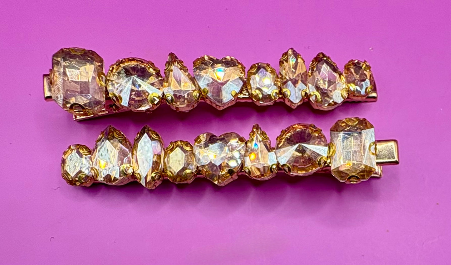 Stylish pair of large gemstone hair slides featuring vibrant colors, perfect for adding a chic and fashionable touch to any hairstyle.
