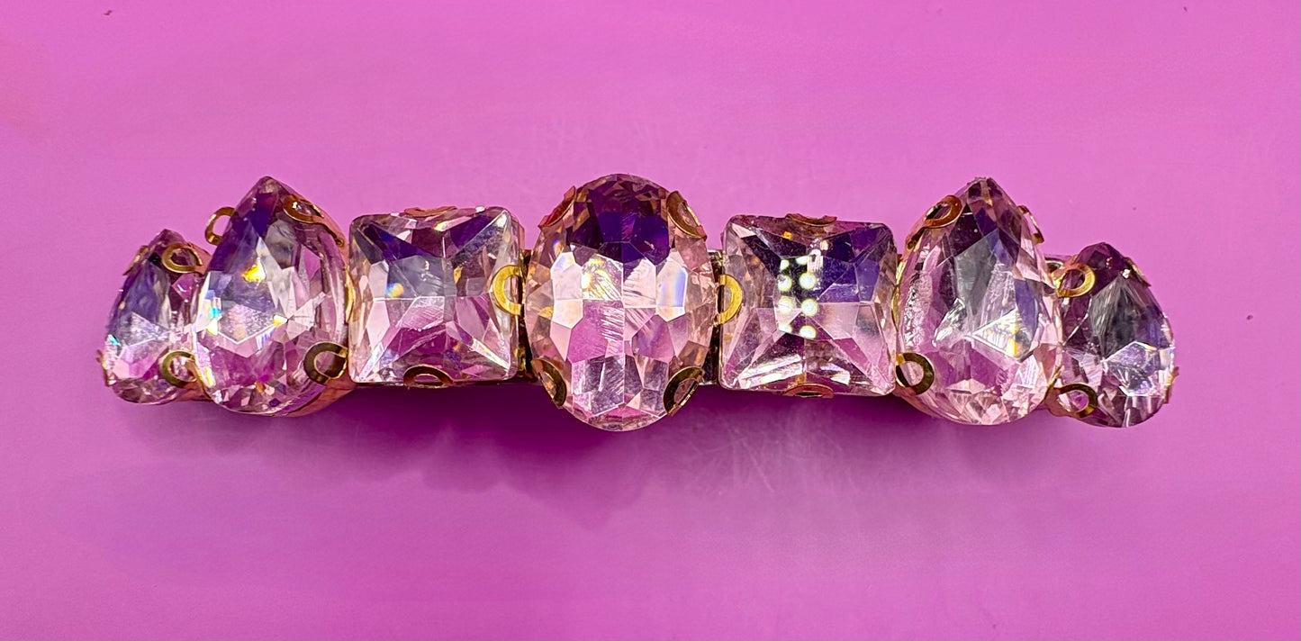 Eye-catching glass rhinestone statement prong clip for hair, perfect for elevating your hairstyle with glamorous sparkle and shine.
