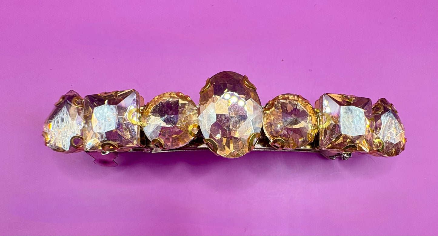 Eye-catching glass rhinestone statement prong clip for hair, perfect for elevating your hairstyle with glamorous sparkle and shine.