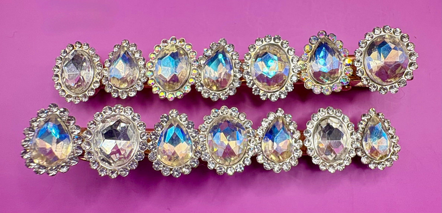Fashionable silver hair clip featuring unique heart and circular designs embellished with colorful gemstones.