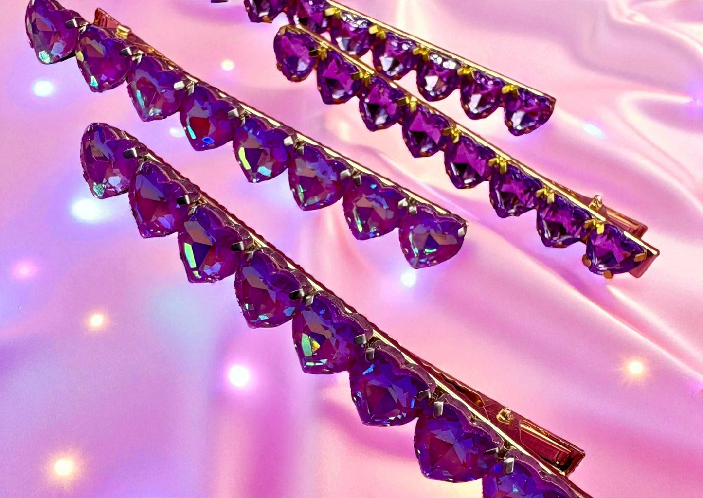 Purple crystal hair clips on a pink background