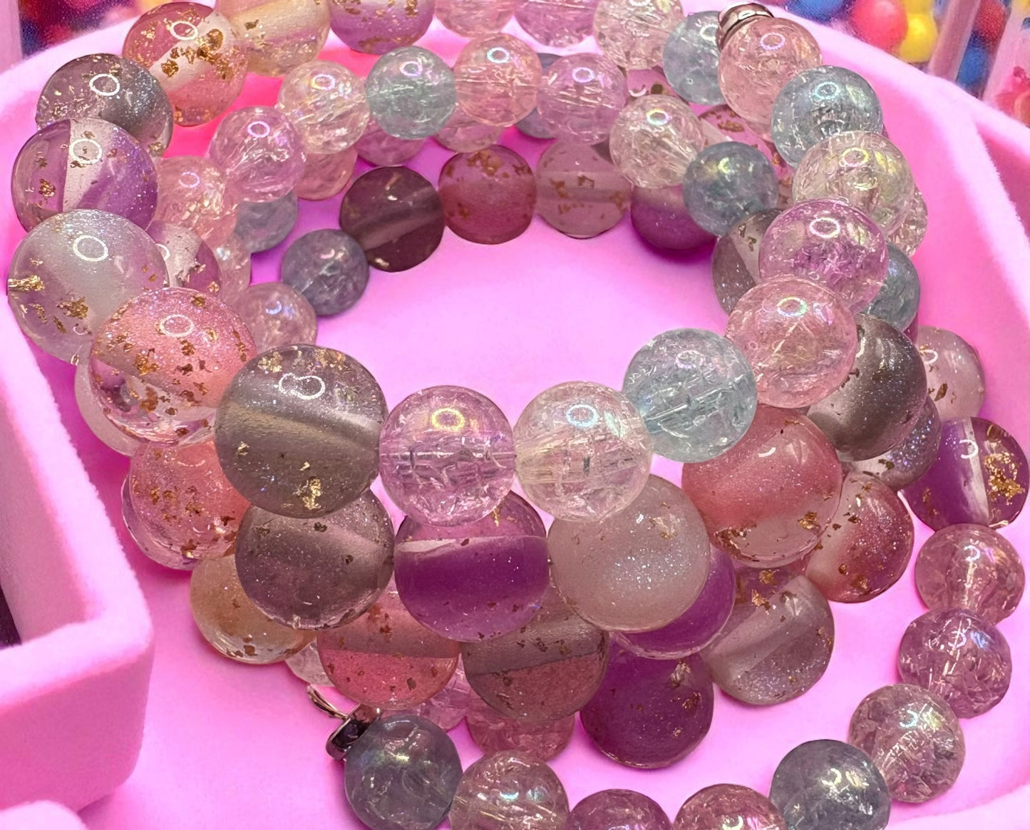 Multicolored beaded bracelet on a pink background