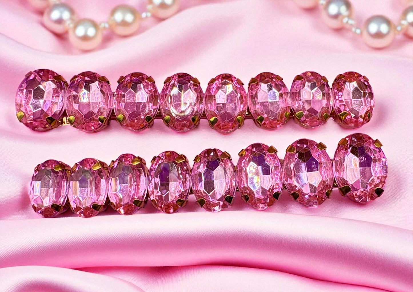 Pink beaded hair clips on a pink fabric background