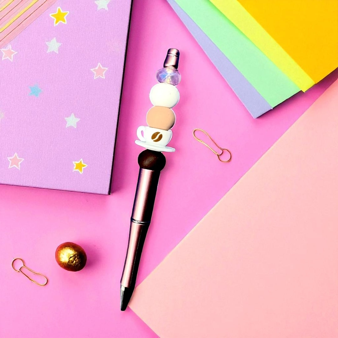 Decorative pen with a coffee-themed design on a colorful background