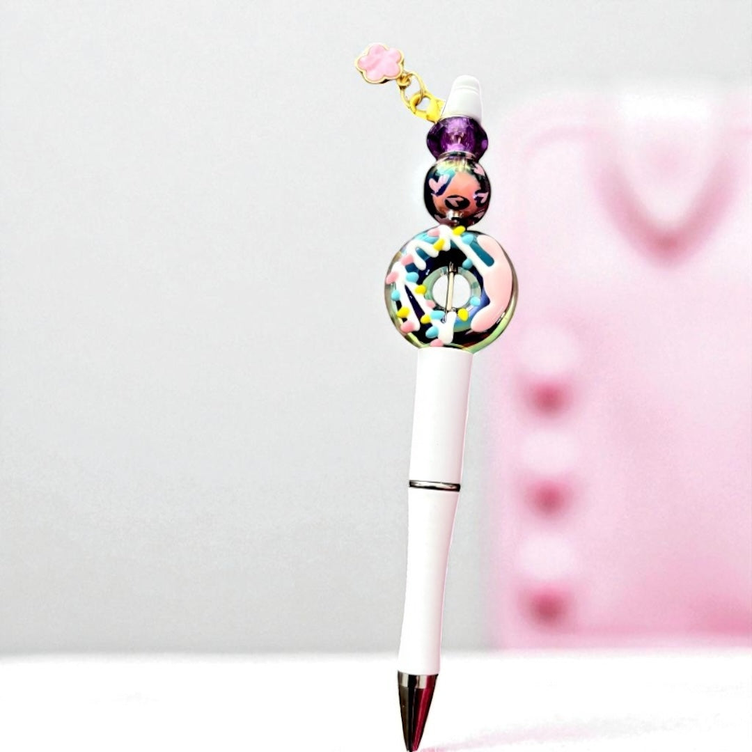 Decorative pen with colorful beads on a white background