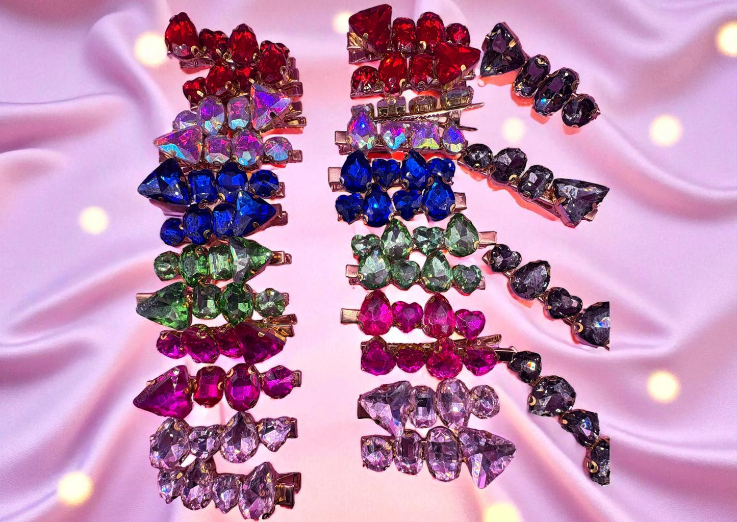 Colorful gemstone hair clips on a pink satin background