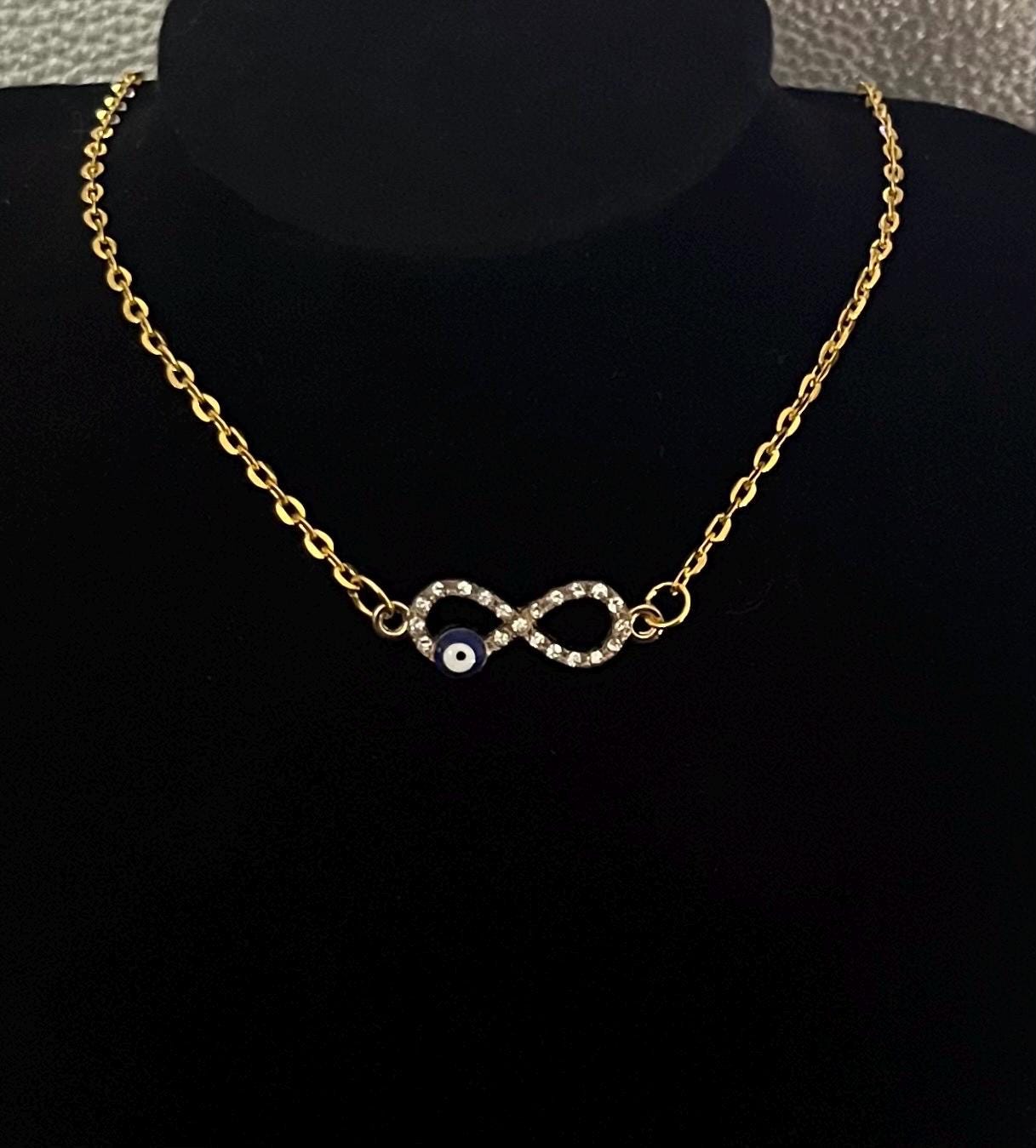 Affinity Diamante Evil Eye Necklace featuring sparkling rhinestones and an elegant design, perfect for adding a touch of glamour and protection to any outfit, ideal for jewelry lovers.