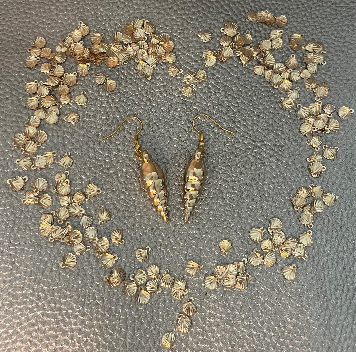 Elegant gold sea shell horn earrings, featuring a unique coastal-inspired design that adds a touch of beachy charm and sophistication to any outfit.