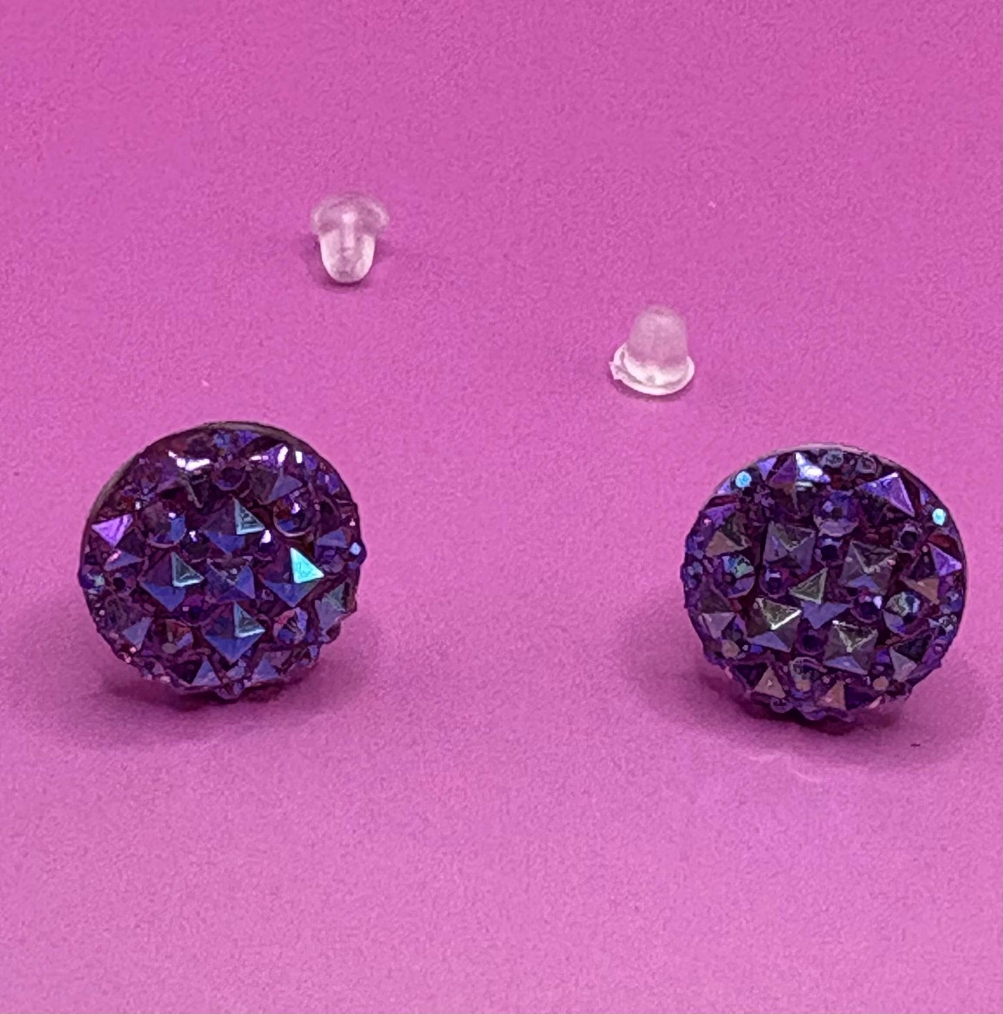 Dazzling purple stud earrings with sparkling gemstones, perfect for adding a touch of elegance to any outfit and enhancing your jewelry collection.