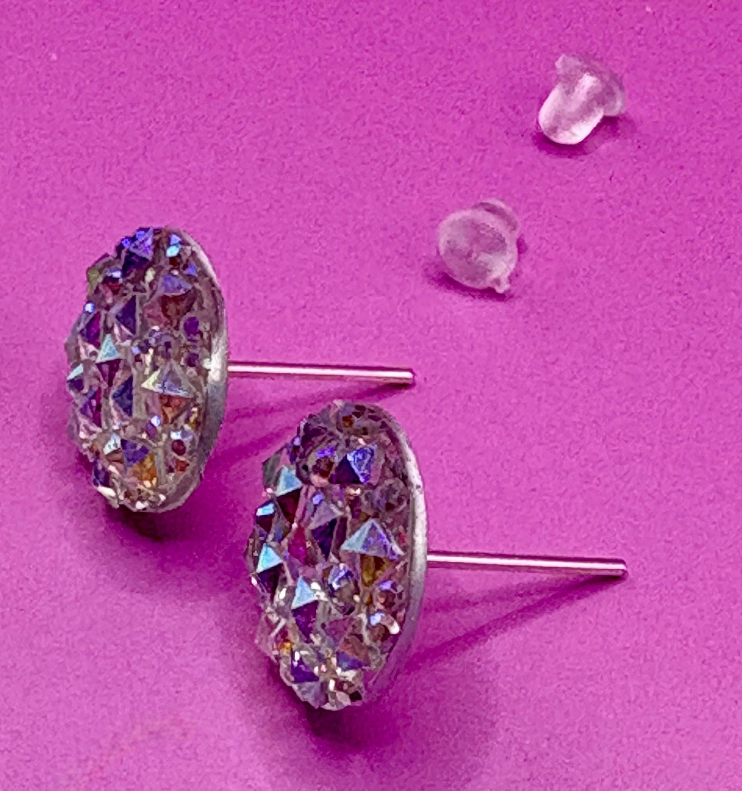 Dazzling silver stud earrings with sparkling gemstones, perfect for adding a touch of elegance and shine to any outfit for both casual and formal occasions.