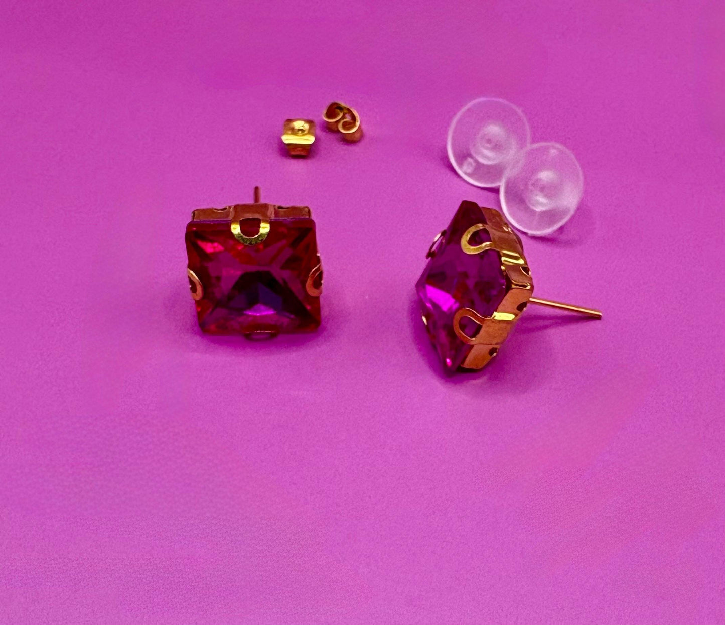Bold fuchsia square stud earrings, featuring a vibrant color and modern design, perfect for making a statement in any outfit and ideal for both casual and formal occasions.