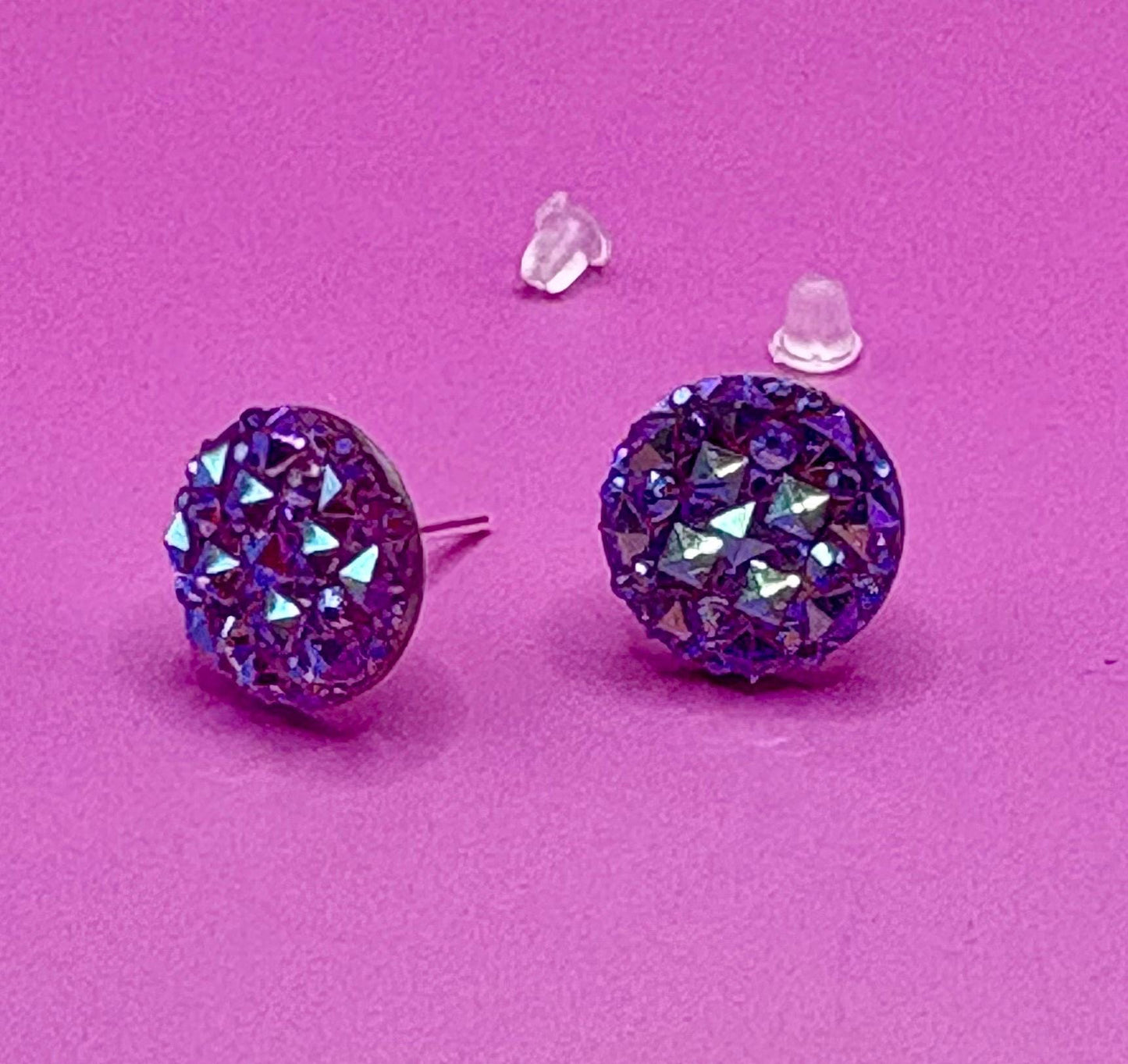 Dazzling purple stud earrings with sparkling gemstones, perfect for adding a touch of elegance to any outfit and enhancing your jewelry collection.
