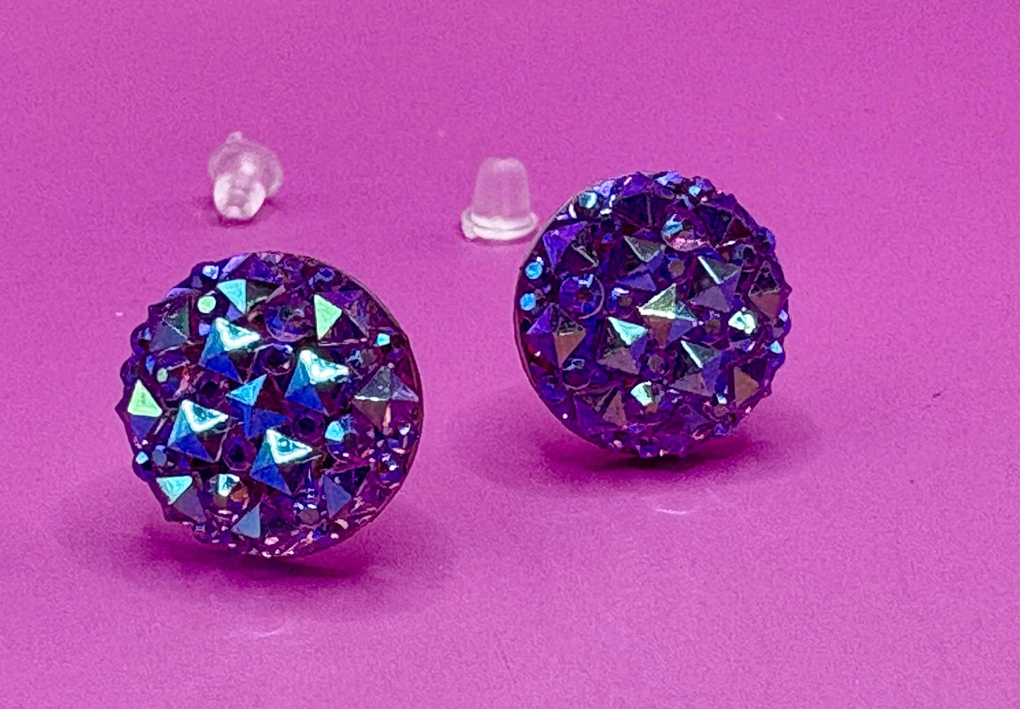 Dazzling purple stud earrings with sparkling gemstones, perfect for adding a touch of elegance to any outfit and enhancing your jewelry collection.