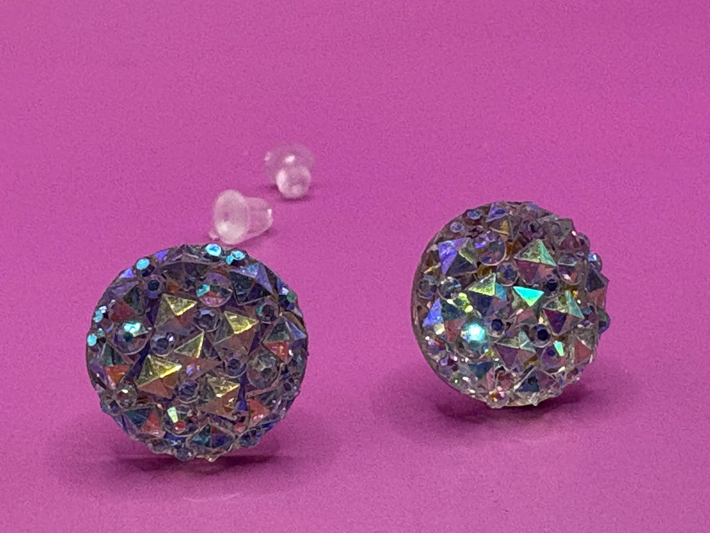 Dazzling silver stud earrings with sparkling gemstones, perfect for adding a touch of elegance and shine to any outfit for both casual and formal occasions.