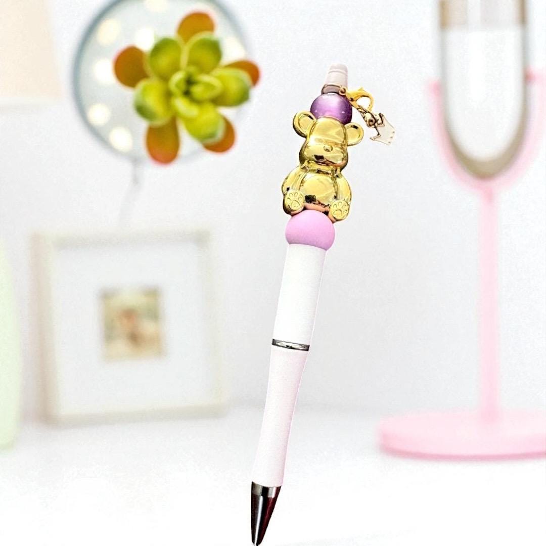 Handcrafted black ballpoint pens with adorable gummy bear and teddy bear charms.
