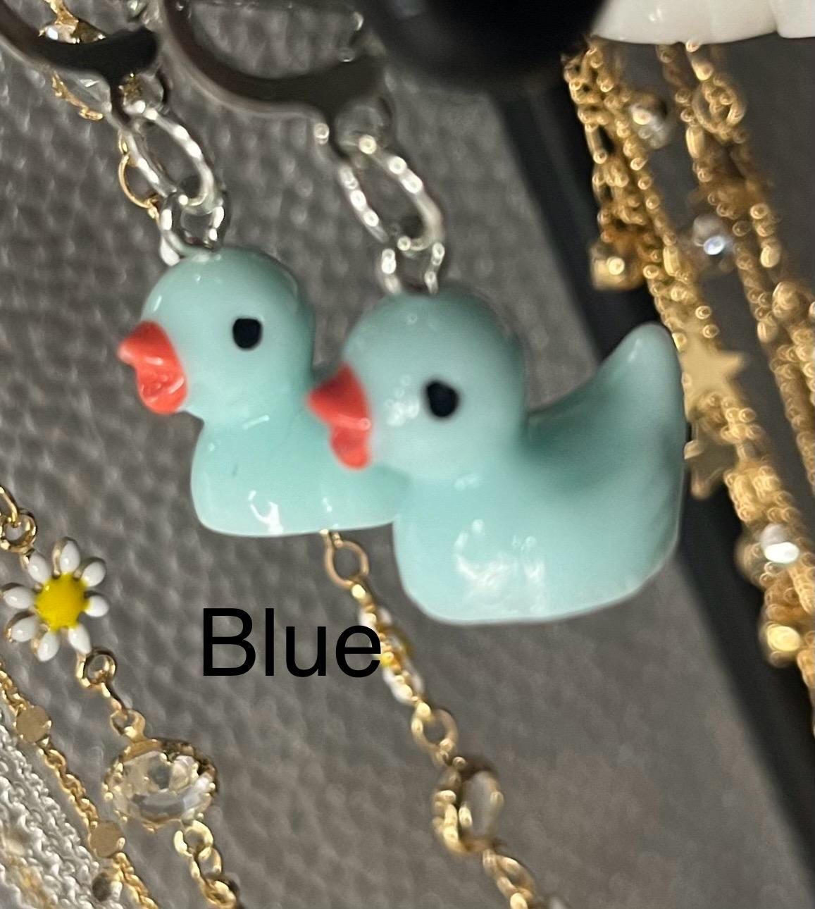 Cute little rubber duck style earrings, dangly drop earrings. available in multiple colours. pink blue yellow purple white costume jewellery