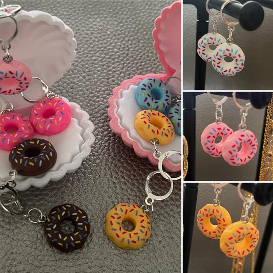 donut earrings, dangly drop earrings. available in multiple colours. pink blue brown white yellow. cartoon style. novelty costume earrings