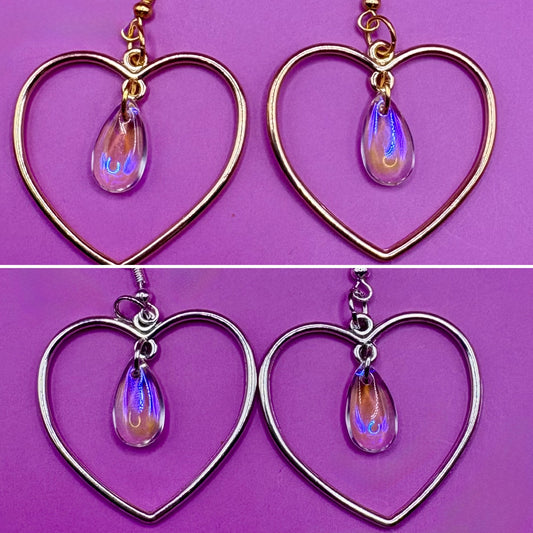 Stylish silver heart hoop dangly earrings, featuring a trendy design perfect for adding a romantic touch to any outfit.