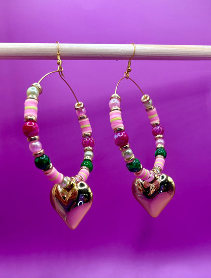 Handmade beaded hoop earrings in pink and green, showcasing vibrant colors and intricate craftsmanship, perfect for adding a playful touch to any outfit and ideal for casual or festive occasions.