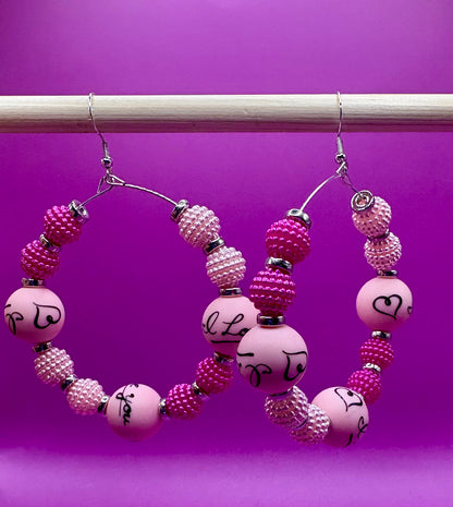 Charming handmade beaded hoop earrings featuring the phrase 'I Love You' in a unique design, perfect for expressing love and adding a personal touch to any outfit, ideal for gifts and special occasions.