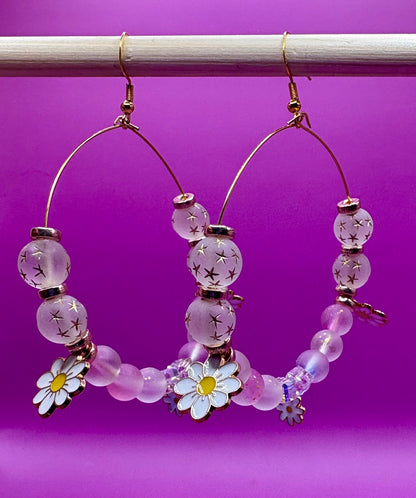 Stylish handmade beaded hoop earrings in a daisy gold design, featuring vibrant colors and floral accents, perfect for adding a touch of elegance to any outfit and ideal for spring and summer fashion.