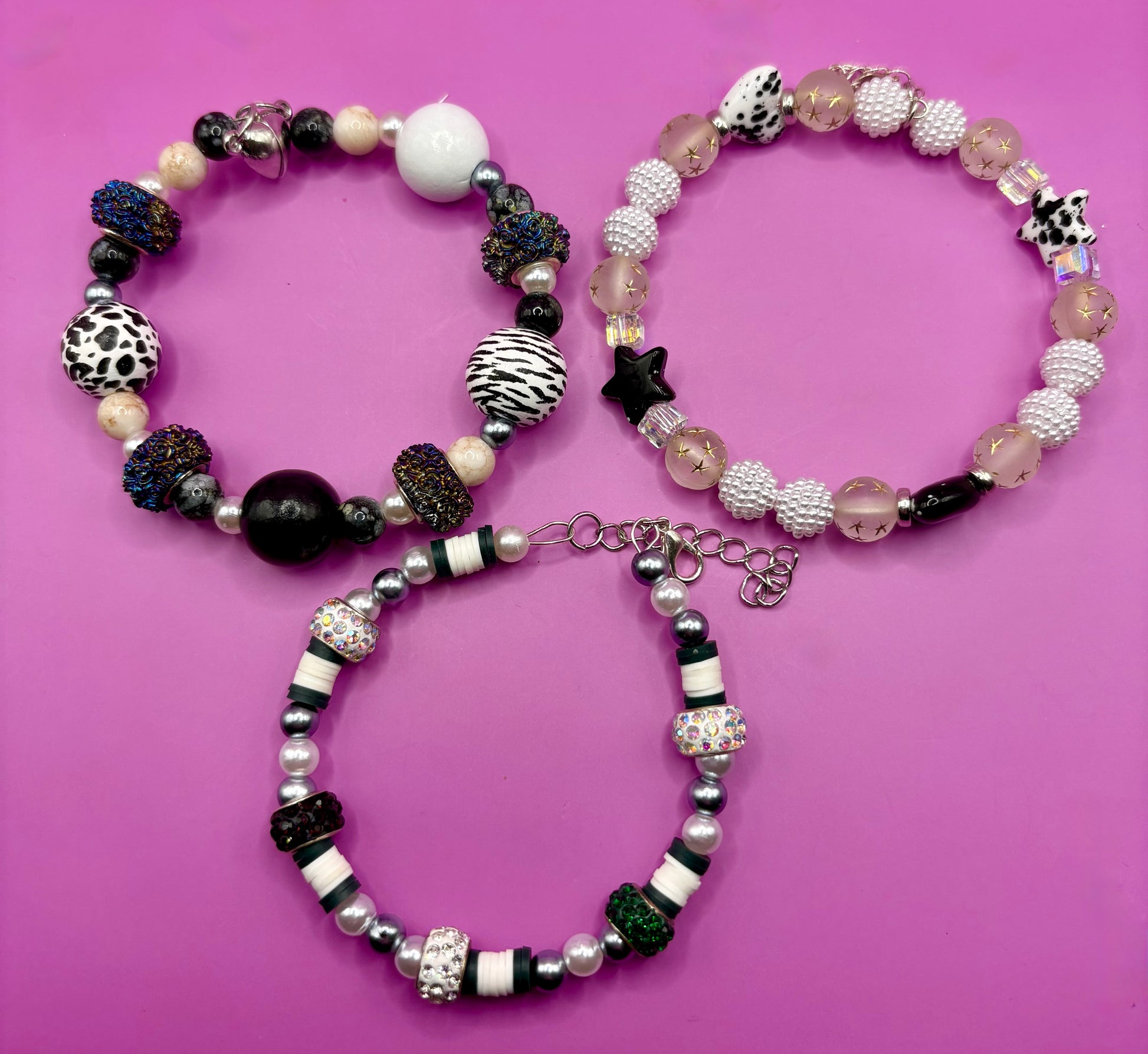 Handmade beaded charm bracelets stacked together, showcasing unique designs and vibrant colors, perfect for adding a personalized touch to any jewelry collection. black and white animal zebra cow print star beads